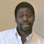 Reggie Simms Man with dark hair, mustache, and goatee